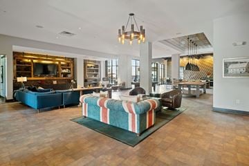 Nashville apartment for rent - A living room with a striped sofa in the middle.