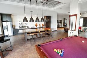 Nashville apartment for rent - A pool table with a red cloth and a white cue ball in the middle.