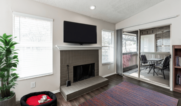 Palm Harbor apartment for rent - A living room with a fireplace and a television mounted above it.