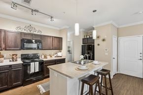 Fort Worth apartment for rent - A kitchen with a white counter top and brown cabinets.