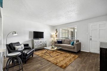 Tyler apartment for rent - A living room with a black leather chair and a white sofa.