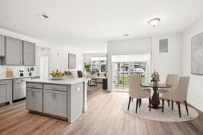 Mount Laurel apartment for rent - A kitchen with a dining table and chairs in the middle of the room.