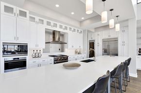 Denver apartment for rent - A modern kitchen with white cabinets and a large island.