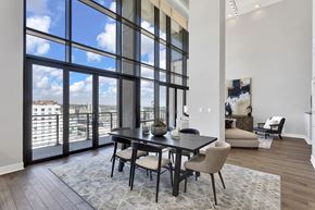 Denver apartment for rent - A dining room with a table and chairs in front of a large window.