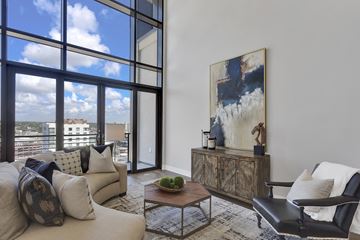 Denver apartment for rent - A living room with a couch, a chair, and a painting on the wall.