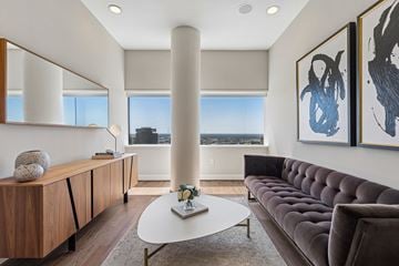 Dallas apartment for rent - A living room with a brown couch and a white coffee table.