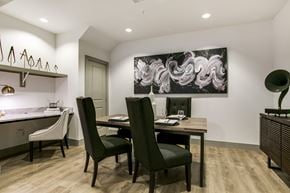 Dallas townhouse for rent - A modern dining room with a large abstract painting on the wall.