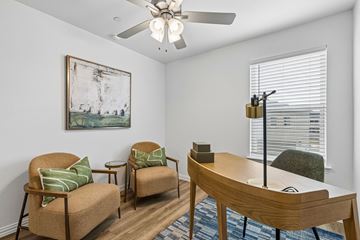 Arlington apartment for rent - A living room with a painting on the wall and a ceiling fan.