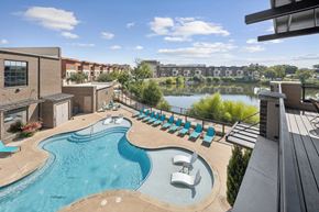 Farmers Branch apartment for rent - A pool with loungers at Midway Urban Village in Farmers Branch Texas