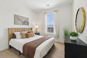 Midlothian apartment for rent - A bedroom with a large bed and a painting of a bull on the wall.