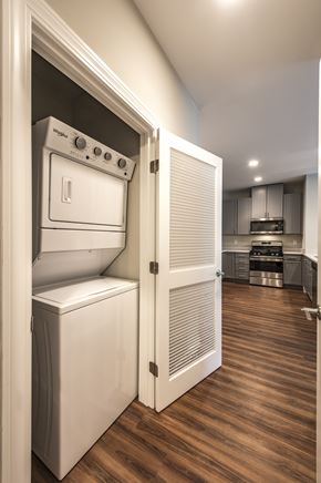 Salem apartment for rent - A white oven and dishwasher are in a kitchen with wooden floors.