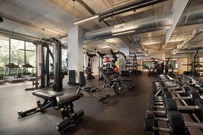 Miami apartment for rent - A gym with a variety of equipment including weights and machines.