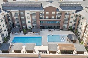 Forney apartment for rent - A large apartment complex with a pool in the middle.