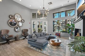 Phoenix apartment for rent - A living room with a grey couch and a fireplace.