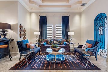 Doral apartment for rent - A living room with a large rug and a glass coffee table.