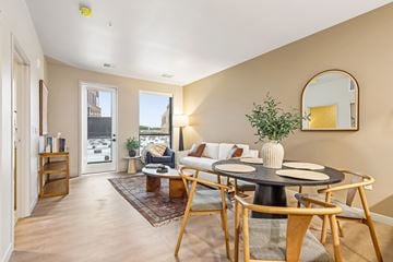Wauwatosa apartment for rent - A living room with a round table and chairs.