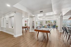 Peoria apartment for rent - A room with a pool table and chairs.