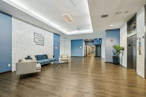 St. Petersburg apartment for rent - A spacious hallway with a blue wall and a white brick pattern on the wall.