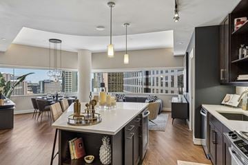 Dallas apartment for rent - A modern kitchen with a large island and a view of the city.