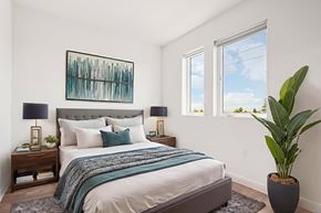 Pasadena apartment for rent - A bedroom with a large bed and a painting on the wall.