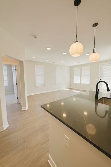 Zionsville apartment for rent - A kitchen with a black counter top and a sink.