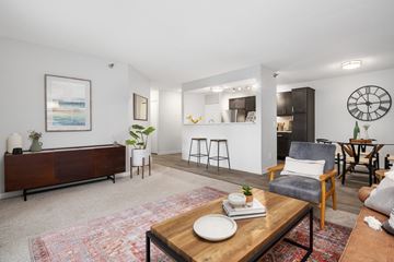 Coon Rapids apartment for rent - A living room with a wooden coffee table in the center.
