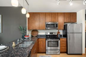 St. Louis Park apartment for rent - a kitchen with granite counter tops and stainless steel appliances at Verge Apartments in St. Louis Park, MN