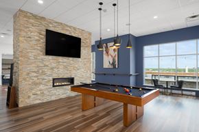 St. Louis Park apartment for rent - a games room with a pool table and a fireplace at Verge Apartments in St. Louis Park, MN