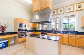 Gainesville apartment for rent - A kitchen with wooden cabinets and a large island.