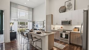 Frisco apartment for rent - A modern kitchen with a dining table and chairs.