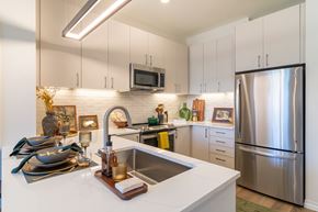 Brighton apartment for rent - a kitchen with stainless steel appliances and white counter tops