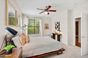 Mckinney apartment for rent - a bedroom with a bed and a ceiling fan