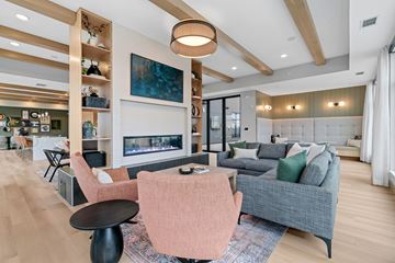 Minneapolis apartment for rent - A modern living room with a fireplace and a painting on the wall.