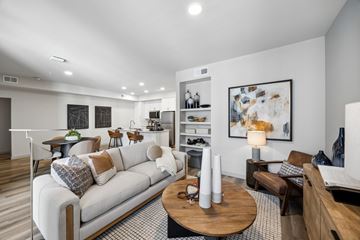 Dallas apartment for rent - A modern living room with a white sofa and a wooden coffee table.