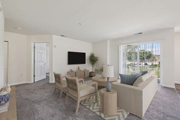 Carlisle apartment for rent - A living room with a grey carpet and a white sofa.