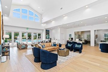 Orlando apartment for rent - A living room with a blue couch and a wooden floor.