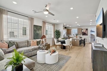 New Braunfels apartment for rent - A modern living room with a grey sofa, a white coffee table, and a television on the wall.