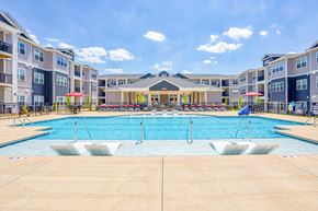 Greensboro apartment for rent - A large swimming pool in front of apartment buildings.