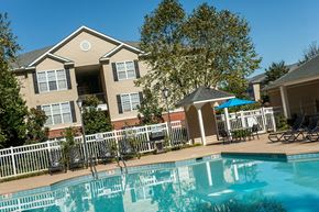 Salisbury apartment for rent - A swimming pool in front of a house with a white picket fence.