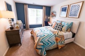 Lynchburg apartment for rent - A bedroom with a bed, nightstand, and window.