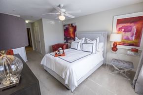 Spartanburg apartment for rent - A bedroom with a large bed and a ceiling fan.