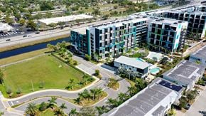 Plantation apartment for rent - A view of a green field and apartment buildings from above.