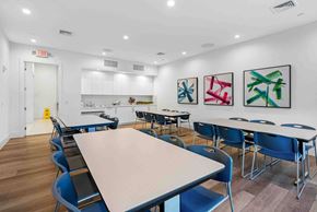 Delray Beach apartment for rent - a dining room with tables and chairs and a kitchen
