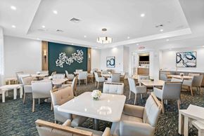 Delray Beach apartment for rent - a dining room with tables and chairs and a large chalkboard in a conference room