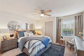Brandon apartment for rent - A bedroom with a large bed and a ceiling fan.