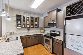 Charlotte apartment for rent - a kitchen with wooden cabinets and granite countertops