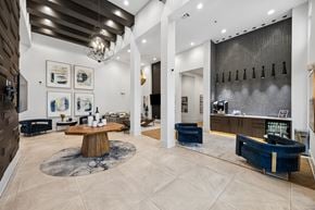Fort Worth apartment for rent - A modern living room with a wooden coffee table and blue sofa.