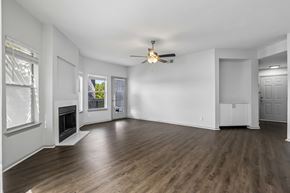 Orlando apartment for rent - A spacious room with a fireplace and wood flooring.
