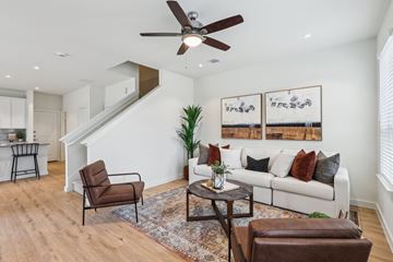 Fulshear apartment for rent - A living room with a brown leather chair and a white couch.