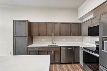 Stanwood apartment for rent - A kitchen with a white counter top and stainless steel appliances.
